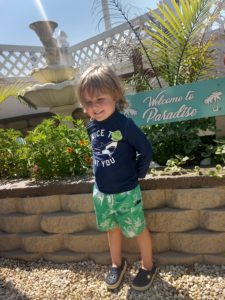 This Little Boy Was So Happy On Vacation At Lorry's Motel By The Welcome To Paradise Sign He Wanted His Picture On The Internet